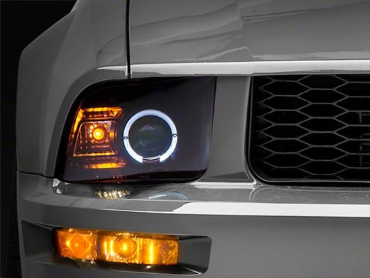Raxiom 05-09 Ford Mustang Halogen 2010 Style LED Halo Headlights-Blk Hsng(Clear Lens/Excludes GT500)